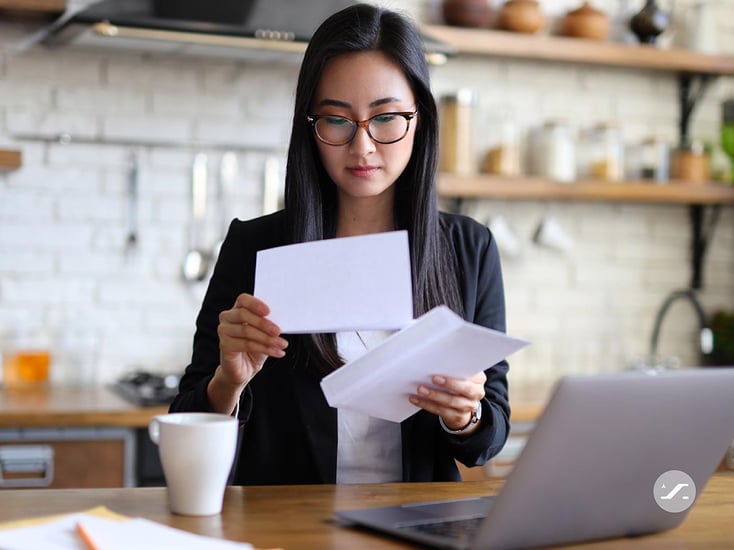 millennial woman opening mail