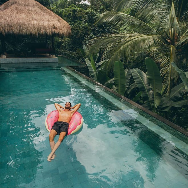 Man relaxing in a pool in the tropics. 