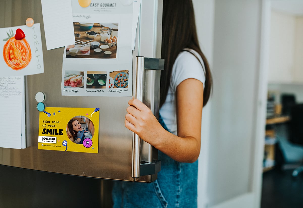 girl-picking-something-eat-out-fridge-with-postcard