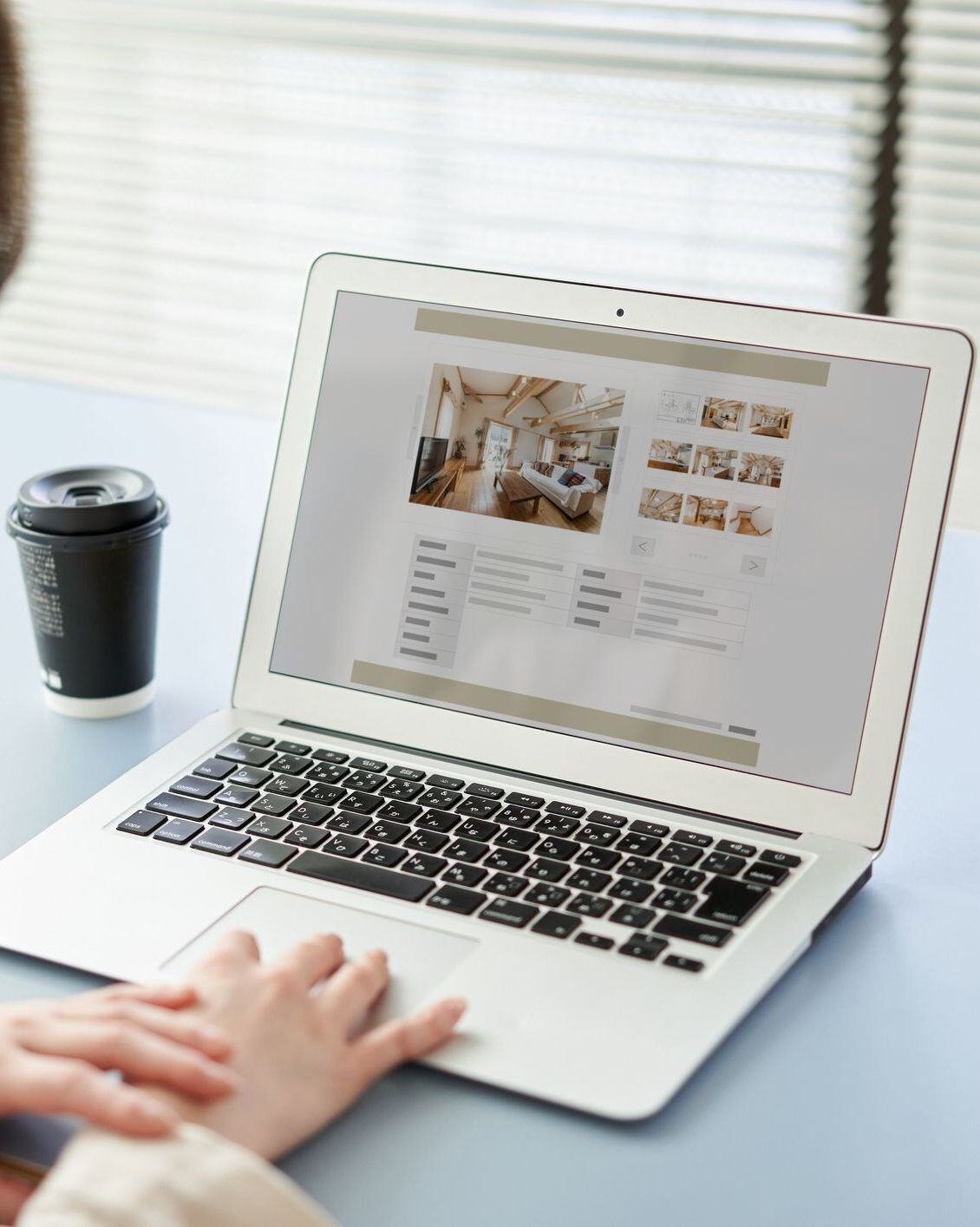 Person scrolling through website on laptop