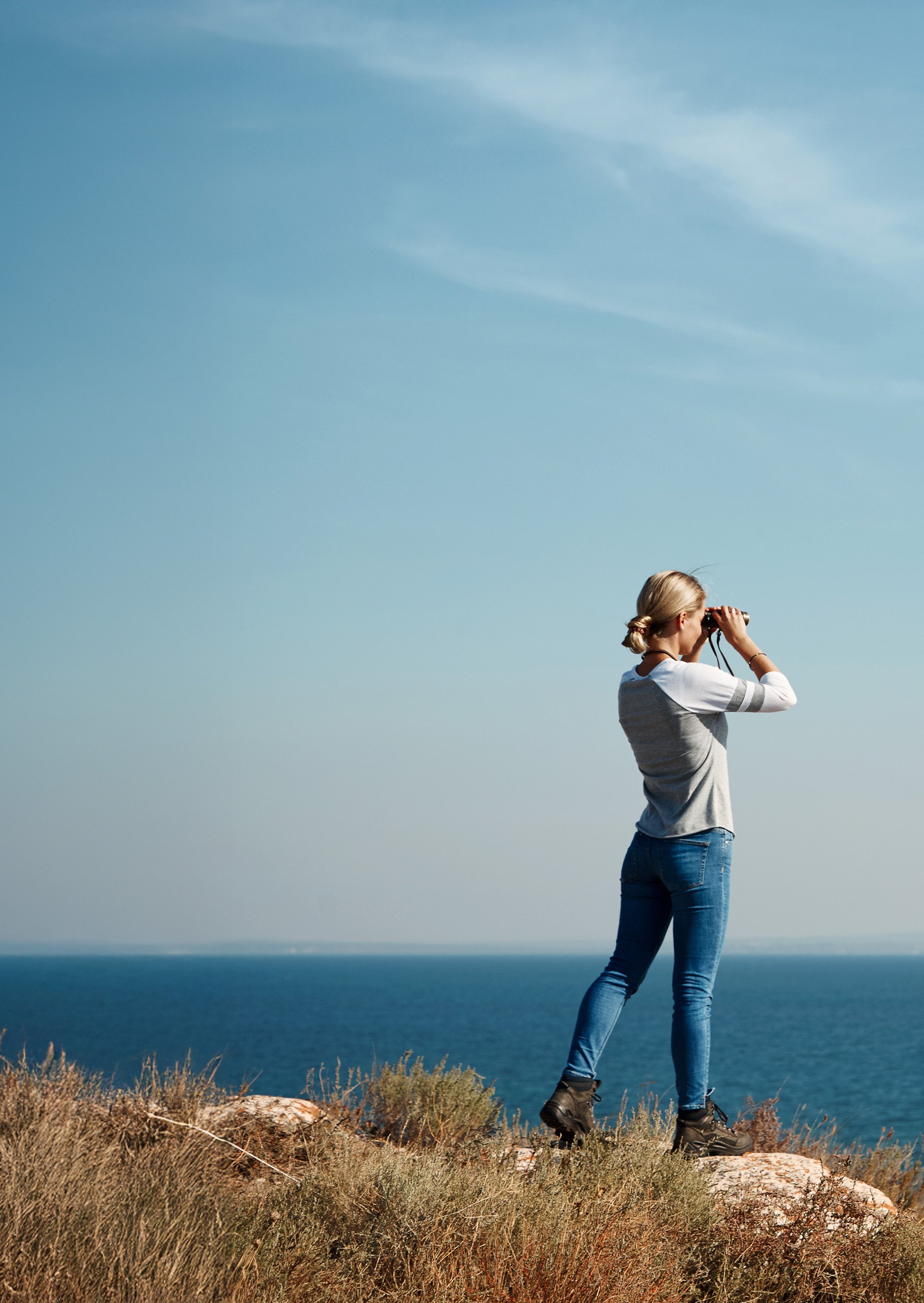 woman-looking-through-binoculars